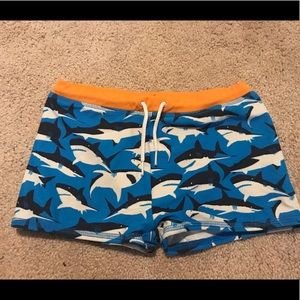 Mini Boden shark sleek swim trunks in size 7-8y
